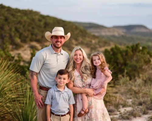 Family portrait in a scenic outdoor setting.